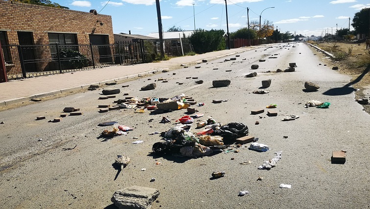 [File Image]: Rocks and rubble seen strewn on a road during a protest in Bloemfontein.