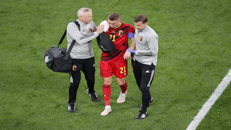Belgium's Timothy Castagne receives medical attention after clashing heads.