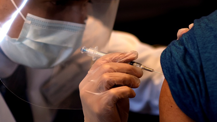 FILE PHOTO: A person receives a dose of the Johnson & Johnson coronavirus disease (COVID-19) vaccine.
