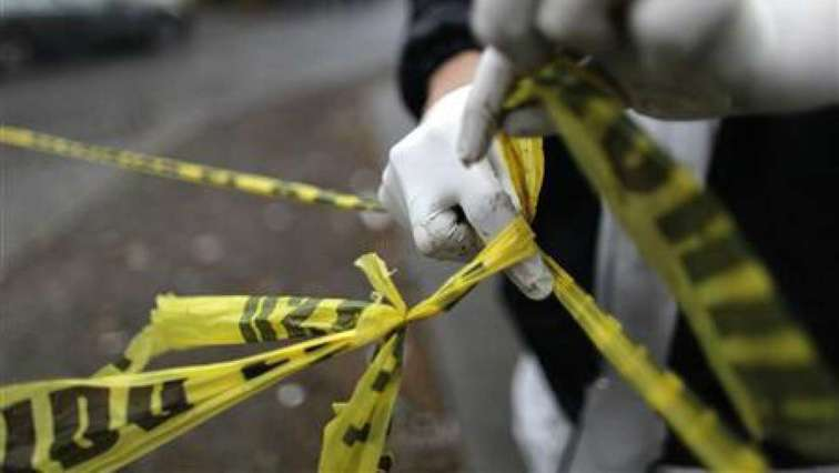 A police tape cordons a crime scene.