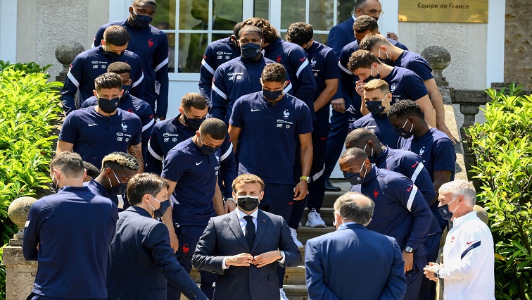 French President Emmanuel Macron poses for pictures with French players before a lunch in Clairefontaine-en-Yvelines, France June 10, 2021, ahead of the UEFA EURO 2020 football competition.