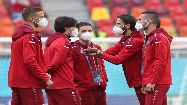 North Macedonia players wearing face masks on the pitch before the match.