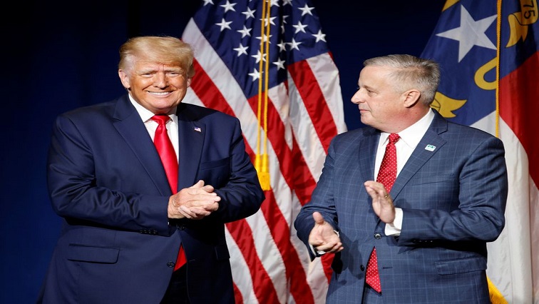 Former US President Donald Trump is introduced by North Carolina Republican Party chairman Michael Whatley before speaking at the North Carolina GOP convention dinner in Greenville, North Carolina.