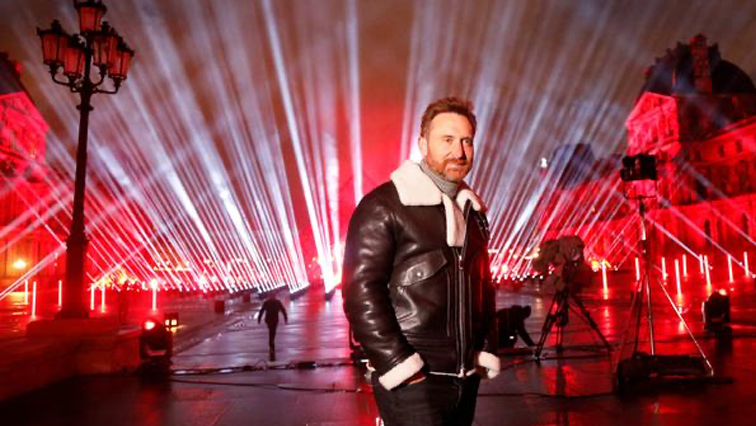 French DJ David Guetta poses in front of the Louvre Pyramid before performing the 'United at Home' fundraising live concert for New Year's Eve, in Paris.