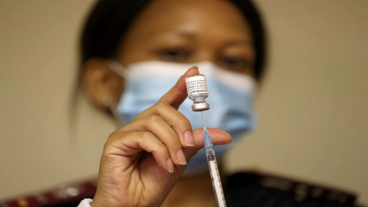 A nurse prepares a syringe with a dose of the Moderna coronavirus disease vaccine.