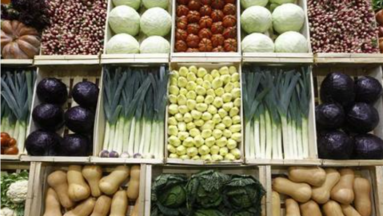 Vegetables, including cabbages, leeks, endives and squash are presented in wooden crates at the Paris Farm Show in Paris on February 27, 2012.