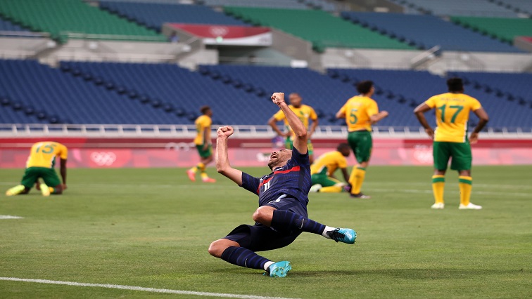 Teji Savanier of France celebrates scoring their fourth goal as South Africa players look dejected.