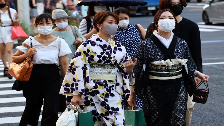 Women in traditional costumes and wearing protective masks amid the coronavirus disease (COVID-19) outbreak make their way in Tokyo, Japan, July 27, 2021.