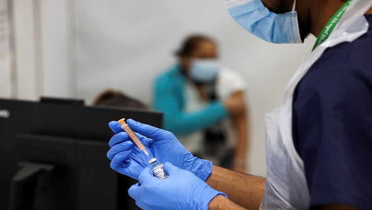 A health worker prepares an injection with a dose of Astra Zeneca coronavirus vaccine, at a vaccination centre in Westfield Stratford City shopping centre, amid the outbreak of coronavirus disease (COVID-19), in London, Britain.