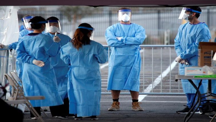 Medical students and physician assistants from Touro University Nevada wait to screen people in a temporary parking lot shelter at Cashman Centre, with spaces marked for social distancing to help slow the spread of coronavirus disease (COVID-19) in Las Vegas, Nevada, US.
