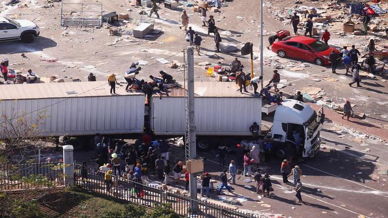 South Africans pouncing on a truck during the unrest, which followed former president Jacob Zuma's jailing.