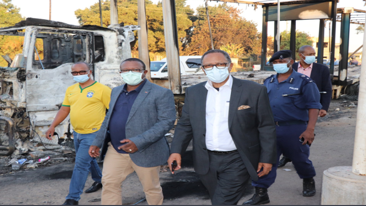 Acting Prime Minister Themba Masuku (right) tours business property that was destroyed in Matsapha during protests.