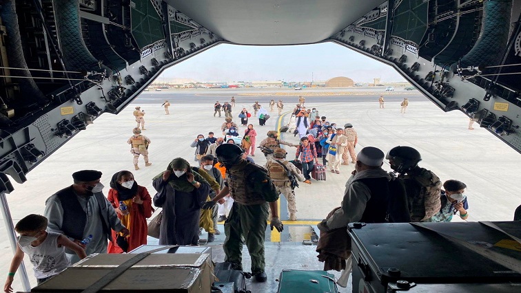 Spanish citizens residing in Afghanistan and Afghans board a military plane as part of their evacuation, at the Hamid Karzai International Airport in Kabul, Afghanistan, August 18, 2021.