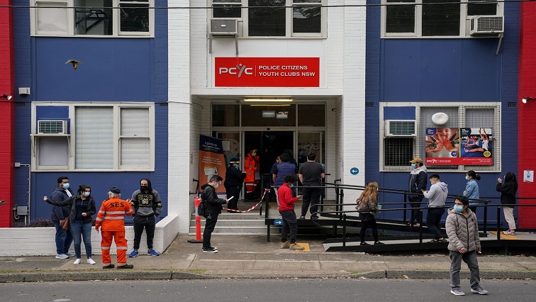 People wait in line outside a coronavirus disease (COVID-19) vaccination clinic in the Bankstown suburb during a lockdown to curb an outbreak of cases in Sydney, Australia, August 25, 2021.