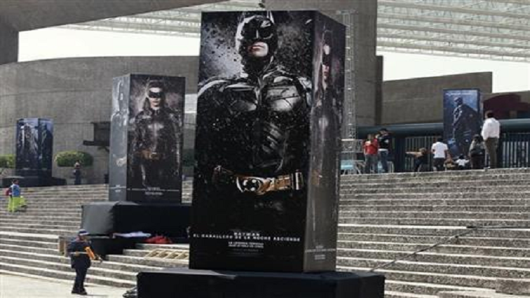 [File photo] Posters of the film "The Dark Knight Rises" are displayed outside as people wait for the midnight premiere of the final instalment of Christopher Nolan's Batman trilogy at the National Auditorium in Mexico City.