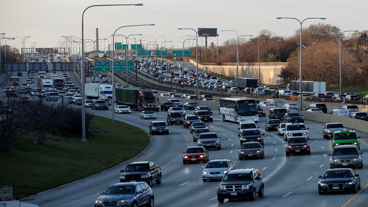 Vehicles travel in heavy traffic on a freeway.