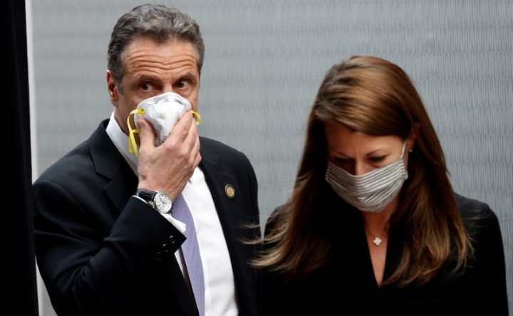 File photo: New York Governor Andrew Cuomo holds a protective mask to his face as he and Secretary to the Governor Melissa DeRosa arrive for a daily briefing at New York Medical College during the outbreak of the coronavirus disease