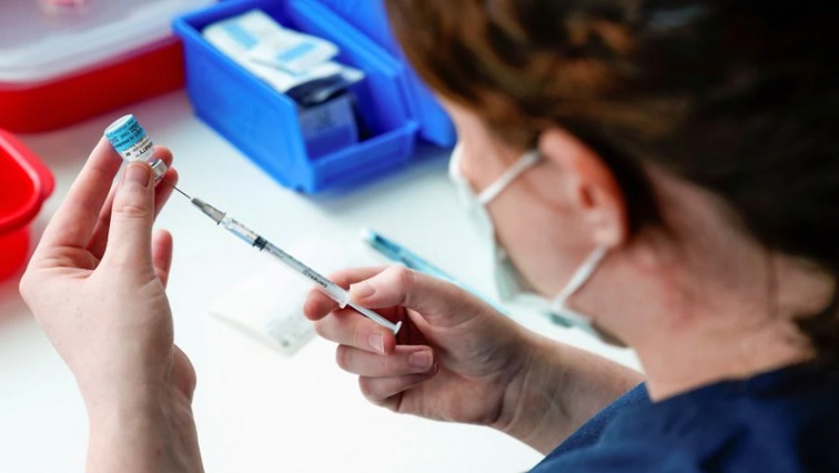 A healthcare professional prepares a dose of the Pfizer coronavirus disease (COVID-19) vaccine.