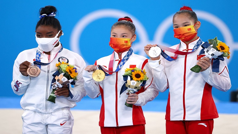 Gold medallist Guan Chenchen of China, silver medallist Tang Xijing of China and bronze medallist Simone Biles of the United States pose with medals.