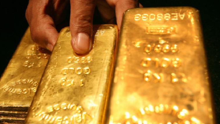 A person shows gold bars in the picture.