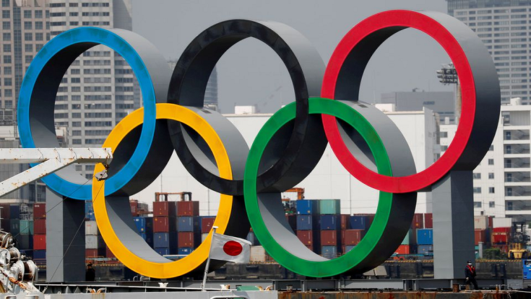 Olympic rings are seen behind Japan's national flag, amid the coronavirus disease (COVID-19) outbreak, at the waterfront area at Odaiba Marine Park in Tokyo, Japan, on August 6, 2020.