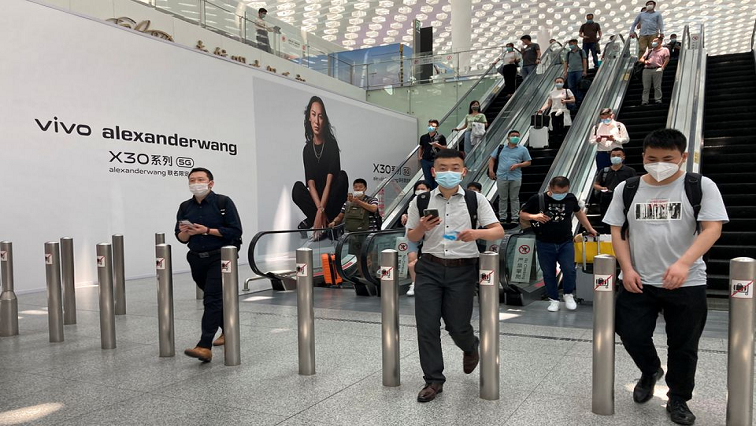 FILE PHOTO: Travellers wearing face masks following the coronavirus disease (COVID-19) outbreak.