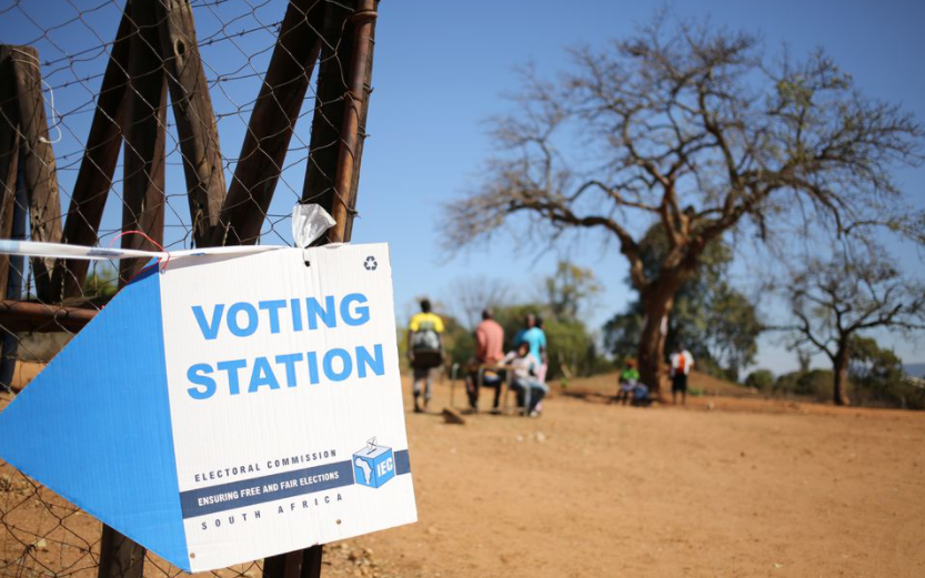 Locals are seen outside a polling station during tense local munincipal elections in Vuwani, South Africa's northern Limpopo province, August 3, 2016