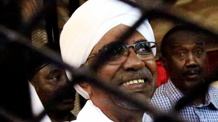 Sudan's former president Omar Hassan al-Bashir smiles as he is seen inside a cage at the courthouse where he is facing corruption charges, in Khartoum, Sudan August 31, 2019. REUTERS/Mohamed Nureldin Abdallah/File Photo