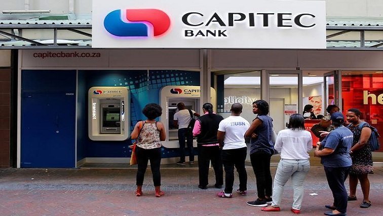 Customers queue to draw money from an ATM outside a branch of South Africa's Capitec Bank in Cape Town, South Africa March 15, 2016.