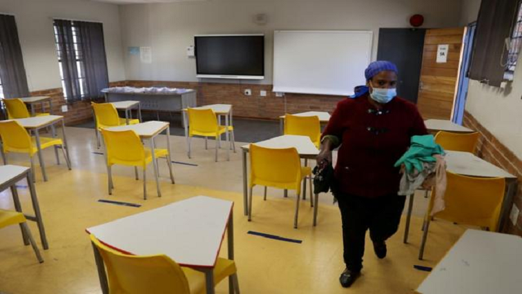 [File Image] A worker walks past safely spaced desks following safe distancing measures amid the spread of the coronavirus disease (COVID-19) outbreak, at the Seshegong secondary school in Olivenhoutbosch, South Africa, May 28, 2020.
