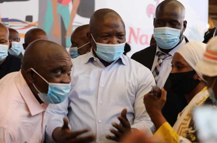 Deputy President David Mabuza and other government officials engage with people at a vaccination site in the North West