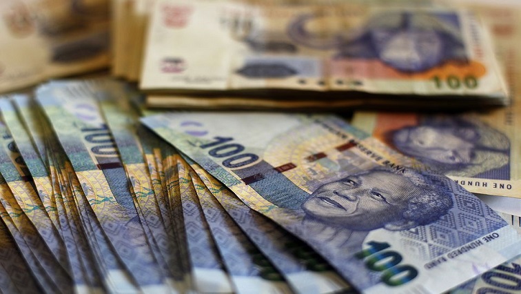 South African bank notes featuring an image of former South African President Nelson Mandela are displayed.