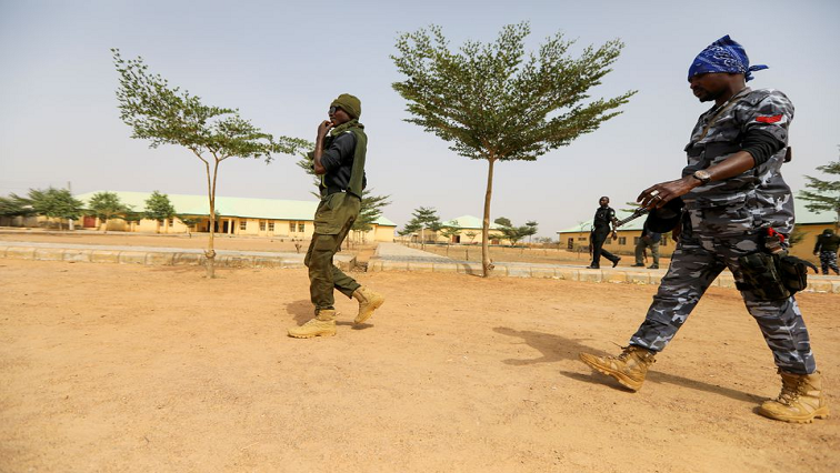 [File photo] Police officers walk at the JSS Jangebe school, a day after over 300 school girls were abducted by bandits, in Zamfara, Nigeria February 27, 2021.