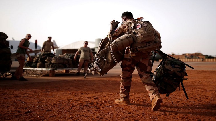 A French soldier leaves with his backpack at the Operational Desert Platform Camp (PfOD) during the Operation Barkhane in Gao, Mali.