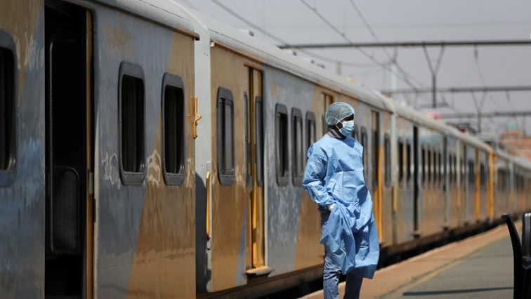 (File) A health worker stands close to a train in Springs, August 21, 2021.