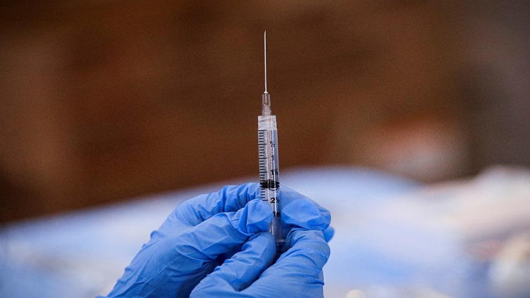 FILE PHOTO: A syringe is filled with a dose of Pfizer's COVID-19 vaccine at a pop-up community vaccination center.