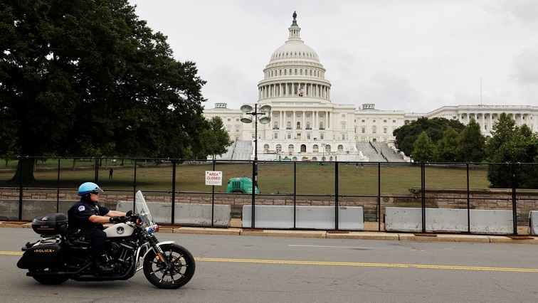 A US Capitol Police officer patrols the unscalable fence erected around the Capitol ahead of an expected rally Saturday in support of the Jan. 6 defendants in Washington, US September 17, 2021.