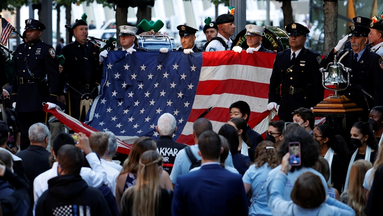The 9/11 American flag is presented as the national anthem is performed during a ceremony marking the 20th anniversary of the September 11, 2001 attacks in New York City, New York, U.S., September 11, 2021. REUTERS/Brendan McDermid