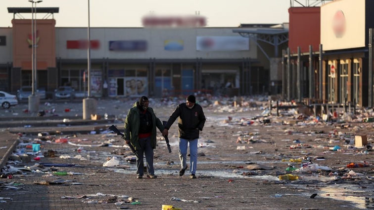 Members of a private security walk at a looted shopping mall in Vosloorus, South Africa, amid violent protests across the country .July 14, 2021.