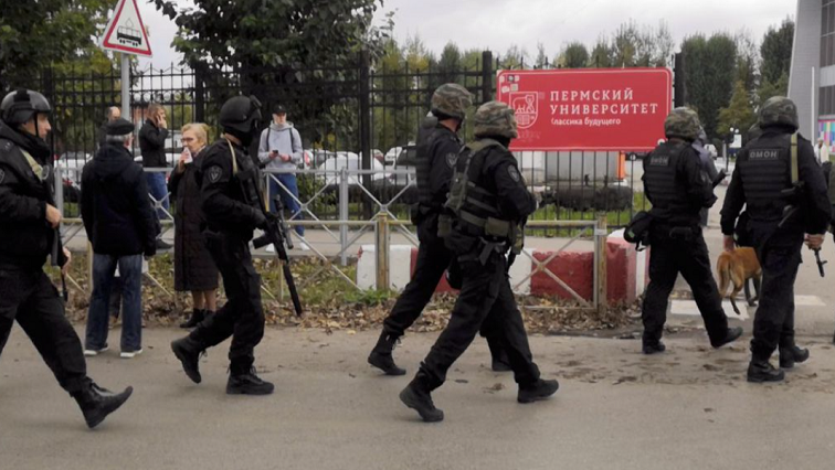Law enforcement officers work near the scene after a gunman opened fire at the Perm State University in Perm, Russia September 20, 2021, in this still image taken from video. REUTERS/Anna Vikhareva
