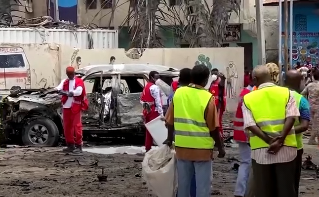Rescue workers and bystanders at the scene of the suicide bomb in Somalia