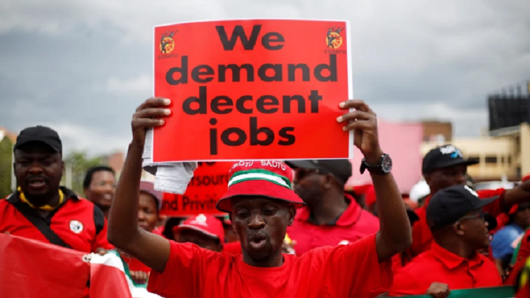 A member of the Confederation of South African Trade Unions (COSATU) holds a placard during a march against job losses in Durban, South Africa, February 13, 2019.
