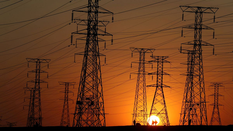 [File photo] Eskom power lines photographed with the sunset behind.