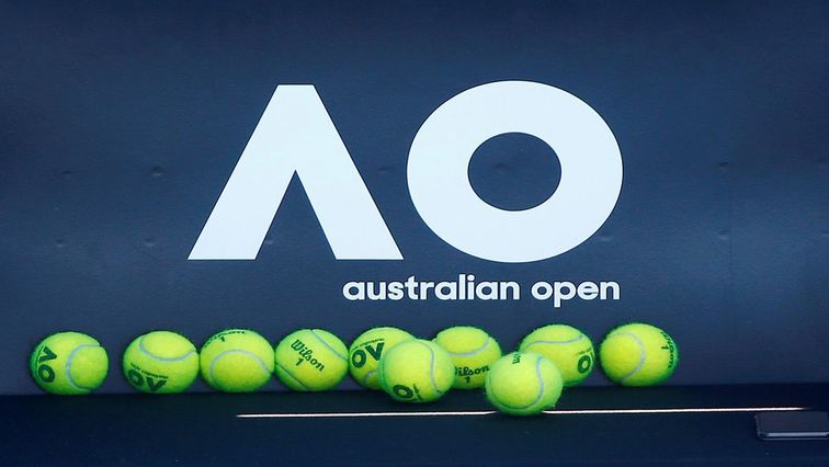 Tennis balls are pictured in front of the Australian Open logo before the tennis tournament.