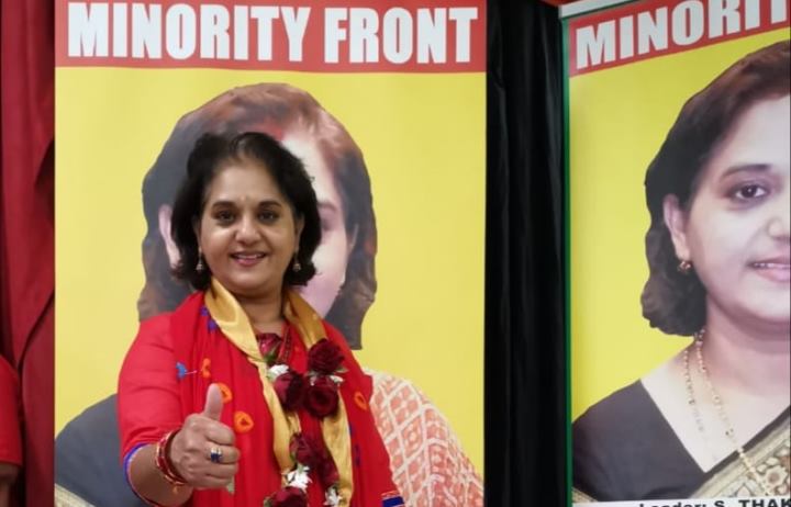 Minority Front leader Shameen Thakur Rajbansi in front of a party poster