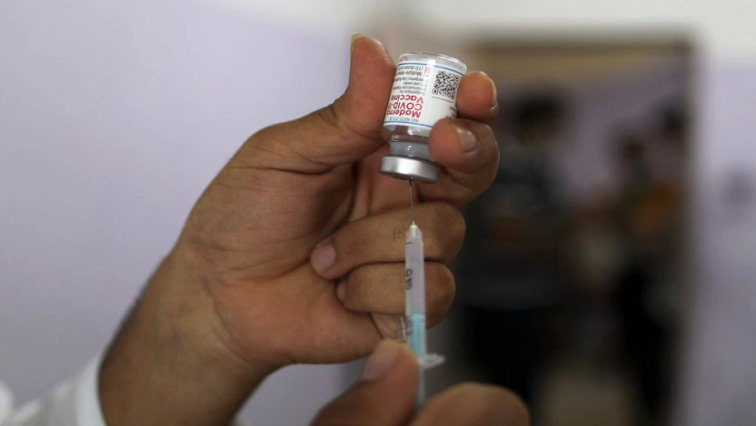 A health worker prepares a dose of the Moderna vaccine against the coronavirus.