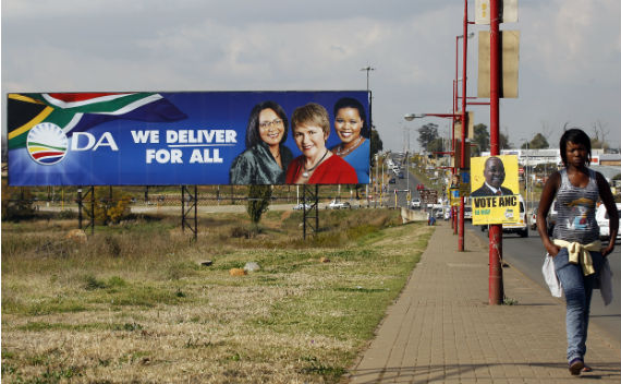 A woman walks past election posters of the African National Congress (ANC) and the official opposition party Democratic Alliance (DA) in Soweto May 9, 2011. (Siphiwe Sibeko/Courtesy Reuters)