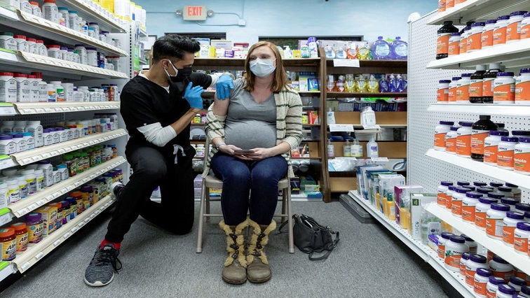 Michelle Melton, who is 35 weeks pregnant, receives the Pfizer-BioNTech vaccine against the coronavirus disease (COVID-19) at Skippack Pharmacy in Schwenksville, Pennsylvania, US.
