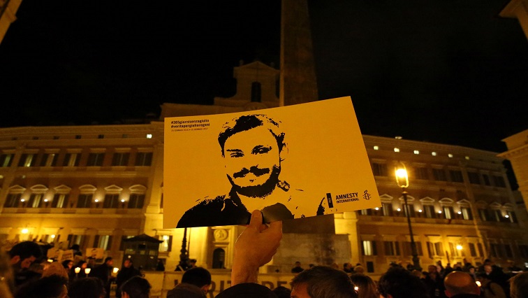 A man holds a placard during a vigil to commemorate Giulio Regeni, who was found murdered in Cairo, in downtown Rome, Italy.