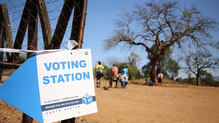 Locals are seen outside a polling station during tense local munincipal elections in Vuwani, South Africa's northern Limpopo province, August 3, 2016.